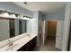 Bathroom with double sink vanity, large mirror, and neutral wall color at 2460 Laurel Gate Ln, Cumming, GA 30040
