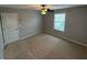 A bedroom featuring neutral walls, carpeted floors, a ceiling fan, and a window letting in natural light at 2460 Laurel Gate Ln, Cumming, GA 30040