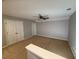 A spacious bonus room with neutral walls, carpet floors, ceiling fan and convenient double door closet at 2460 Laurel Gate Ln, Cumming, GA 30040