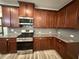 Modern kitchen features granite countertops, stainless steel appliances, and wood cabinets at 2460 Laurel Gate Ln, Cumming, GA 30040