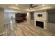 Spacious open-concept living room featuring hardwood floors, fireplace, and built-in shelving at 2460 Laurel Gate Ln, Cumming, GA 30040