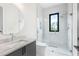 Modern bathroom featuring a glass shower, tiled walls, and a vanity with marble countertop at 4232 Edgewood Ct, Marietta, GA 30068