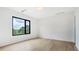 An empty bedroom with bright natural light and a large window overlooking the trees outside at 4232 Edgewood Ct, Marietta, GA 30068