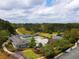 Aerial view of community amenities featuring a large pool, tennis courts, and surrounding greenery in a tranquil setting at 4232 Edgewood Ct, Marietta, GA 30068