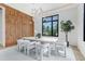 Bright dining room with wood accent wall, modern lighting, and large window at 4232 Edgewood Ct, Marietta, GA 30068