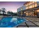 Exterior view of a modern home with a pool and patio, enhanced by evening lighting at 4232 Edgewood Ct, Marietta, GA 30068