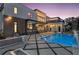 Stunning modern home exterior with a beautiful pool and manicured backyard at twilight at 4232 Edgewood Ct, Marietta, GA 30068