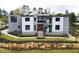 Striking modern home with clean lines, a beautiful stone retaining wall, and a professionally landscaped front yard at 4232 Edgewood Ct, Marietta, GA 30068