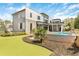 Modern home featuring a backyard pool, manicured lawn, and sleek architectural design at 4232 Edgewood Ct, Marietta, GA 30068