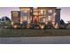 Modern two-story home featuring a stone retaining wall, a manicured lawn, and many large windows at 4232 Edgewood Ct, Marietta, GA 30068