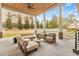 Covered outdoor patio with elegant furniture, a ceiling fan, and views of the pool and backyard at 4232 Edgewood Ct, Marietta, GA 30068