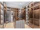 Organize your wardrobe in this spacious walk-in closet, featuring glass shelving and custom storage at 4232 Edgewood Ct, Marietta, GA 30068