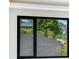 A view from inside a home, showing a window with a black frame and the outside seen through the glass at 4232 Edgewood Ct, Marietta, GA 30068