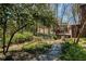 Stone path leading through a beautiful backyard landscape at 520 Willeo Rd, Roswell, GA 30075