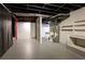 Open basement area with visible pipes, utilities, and painted concrete floor at 520 Willeo Rd, Roswell, GA 30075
