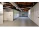 Spacious basement area with painted brick walls, concrete floor and access to a doorway at 520 Willeo Rd, Roswell, GA 30075