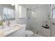 Bright bathroom with a glass shower door, a white vanity, and modern finishes at 520 Willeo Rd, Roswell, GA 30075