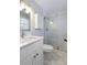 Well-lit bathroom featuring a walk-in shower, toilet, and vanity at 520 Willeo Rd, Roswell, GA 30075