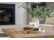 A tray with decorative items, including a vase, candle, and beaded necklace, on a wood coffee table at 520 Willeo Rd, Roswell, GA 30075