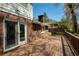 Wooden deck with brick house and sliding glass doors, with trees in background at 520 Willeo Rd, Roswell, GA 30075