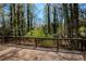 Wooden deck overlooking a serene view of lush trees and natural landscape at 520 Willeo Rd, Roswell, GA 30075