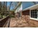 Wide shot of a wooden deck with a brick house in the background at 520 Willeo Rd, Roswell, GA 30075