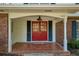 Inviting front porch featuring a red double door, brick pillars, and 'sweet home' welcome mat at 520 Willeo Rd, Roswell, GA 30075