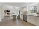 Bright kitchen with white cabinets, stainless steel appliances, and a view into the living room at 520 Willeo Rd, Roswell, GA 30075