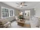 Bright living room featuring hardwood floors, ceiling fan, and a view into the kitchen at 520 Willeo Rd, Roswell, GA 30075