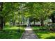 Scenic view of a town square with a monument, walking path, and mature trees at 520 Willeo Rd, Roswell, GA 30075