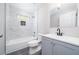 Updated bathroom featuring marble-style tile, modern fixtures, and a shower over tub at 665 S Eugenia Nw Pl, Atlanta, GA 30318