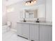 Bathroom with dual sink vanity and marble tile floor at 665 S Eugenia Nw Pl, Atlanta, GA 30318
