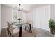 Open-concept dining area with a glass table, louvered closet, and luxury vinyl plank flooring at 665 S Eugenia Nw Pl, Atlanta, GA 30318