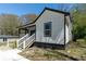 View of the side of the home showcasing fresh white siding and black trim at 665 S Eugenia Nw Pl, Atlanta, GA 30318