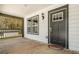 A look at the black front door and the covered porch with a view at 665 S Eugenia Nw Pl, Atlanta, GA 30318