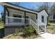 Welcoming covered front porch with white railings and fresh paint details at 665 S Eugenia Nw Pl, Atlanta, GA 30318