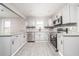 Modern kitchen featuring granite countertops, stainless steel appliances, gray cabinets, and luxury vinyl plank flooring at 665 S Eugenia Nw Pl, Atlanta, GA 30318