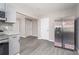 Bright kitchen with stainless steel refrigerator and appliances, gray cabinets, and luxury vinyl plank flooring at 665 S Eugenia Nw Pl, Atlanta, GA 30318