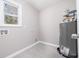 Small laundry room with tile flooring and water heater at 665 S Eugenia Nw Pl, Atlanta, GA 30318