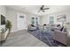 Bright living room with neutral walls, modern gray furnishings, ceiling fan, and luxury vinyl plank flooring at 665 S Eugenia Nw Pl, Atlanta, GA 30318