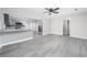 Open-concept living area showcasing modern gray walls, luxury vinyl plank flooring, and stainless steel appliances at 665 S Eugenia Nw Pl, Atlanta, GA 30318