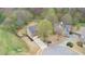An aerial view of a house on a cul-de-sac with fenced backyard, mature trees, and a long driveway at 830 Buffington Way, Canton, GA 30115