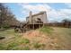 View of backyard featuring a multi-tiered deck and stairs leading to a large lawn at 830 Buffington Way, Canton, GA 30115