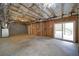 Unfinished basement with exposed rafters and a walkout patio door at 830 Buffington Way, Canton, GA 30115