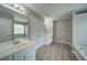 Bright bathroom featuring double sinks, wood-look flooring, and a separate tub at 830 Buffington Way, Canton, GA 30115