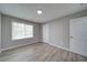 A bedroom featuring wood-look floors and a window for natural light at 830 Buffington Way, Canton, GA 30115