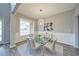 Elegant dining room with modern chandelier, wainscoting and new vinyl flooring at 830 Buffington Way, Canton, GA 30115