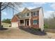 Beautiful two-story home with brick and siding, landscaped front yard, and attached garage on a sunny day at 830 Buffington Way, Canton, GA 30115