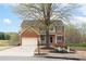 Charming two-story home featuring a brick facade, well-manicured lawn, and an attached two-car garage at 830 Buffington Way, Canton, GA 30115