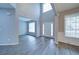 Light-filled foyer with soaring ceilings, white wainscoting and light gray vinyl flooring at 830 Buffington Way, Canton, GA 30115